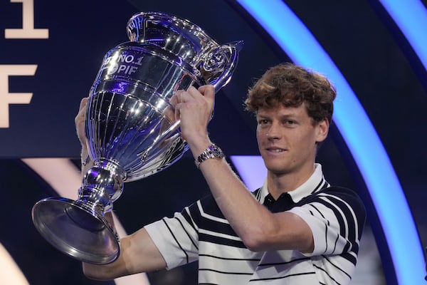 Italy's Jannik Sinner holds the trophy as ATP world best player at the ATP World Tour Finals at the Inalpi Arena, in Turin, Italy, Monday, Nov. 11, 2024. Sinner was presented with the trophy for finishing the year ranked No. 1. (AP Photo/Antonio Calanni)