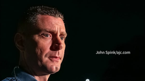 Gwinnett County police Cpl. Collin Flynn speaks with reporters at police headquarters Friday morning after a man was shot and killed on I-85.