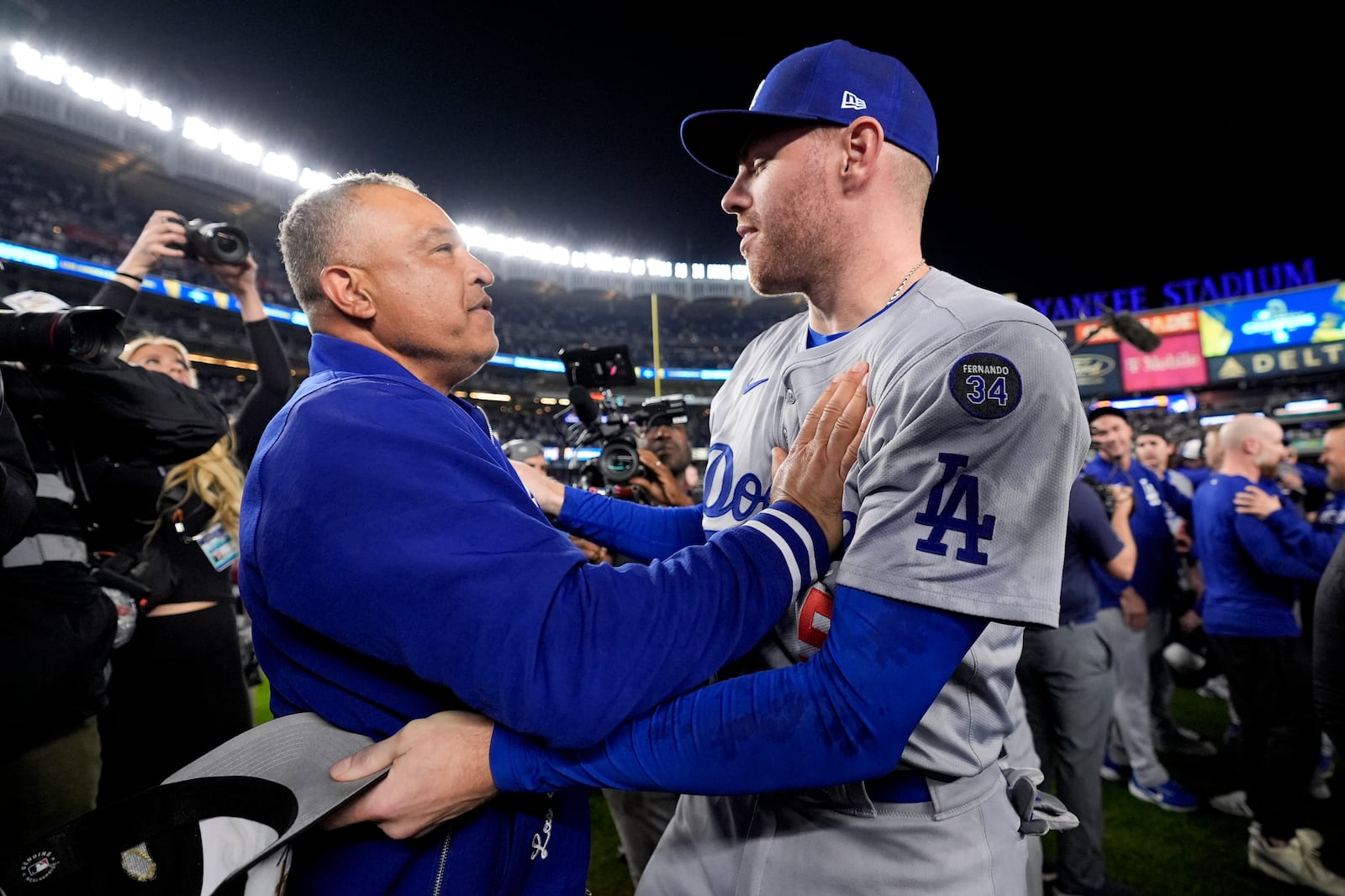 Los Angeles Dodgers manager Dave Roberts and Freddie Freeman celebrate their win against the New York Yankees in Game 5 to win the baseball World Series, Wednesday, Oct. 30, 2024, in New York. (AP Photo/Ashley Landis)