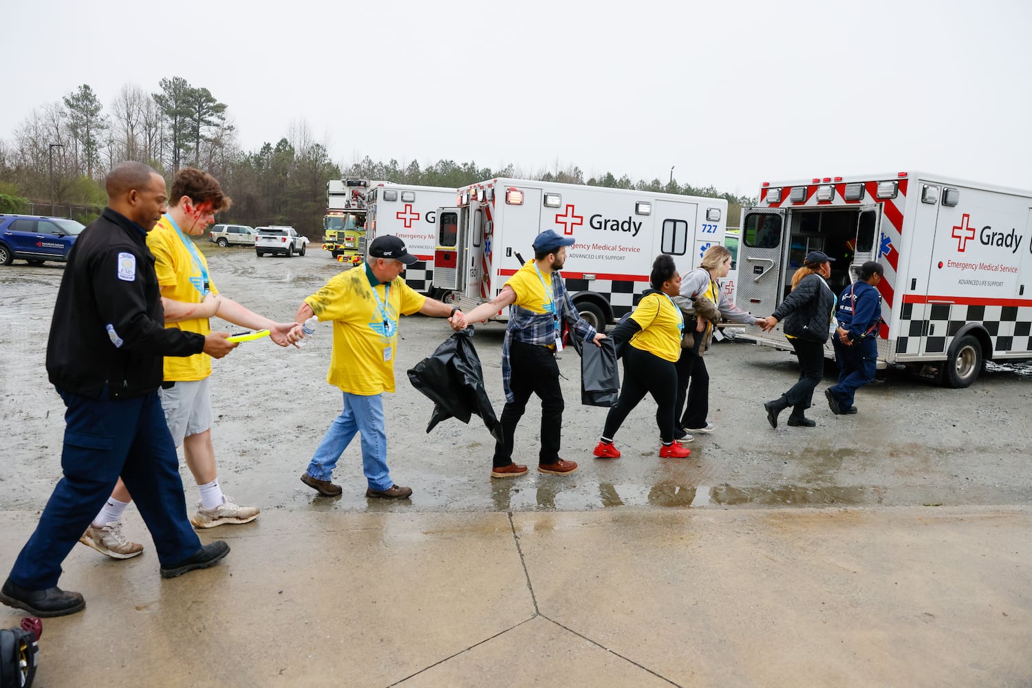 Fake victims follow directions from emergency personnel during a full-scale disaster drill at Hartsfield-Jackson International Airport  with Atlanta Firefighters, law enforcement, rescue personnel, and nearly 70 volunteers who participated in a triennial exercise known as “Big Bird” on Wednesday, March 6, 2024
Miguel Martinez /miguel.martinezjimenez@ajc.com