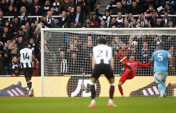 Newcastle United's Alexander Isak, left, scores during the English Premier League soccer match between Newcastle United and Nottingham Forest at St James' Park, Newcastle upon Tyne, England, Sunday, Feb. 23, 2025. (Owen Humphreys/PA via AP)