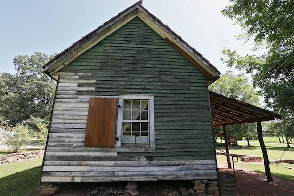 At a time when Georgians are considering which symbols of Southern heritage to preserve, many are unaware of the small number of slave cabins that still exist in the state. Built circa 1850, the Sautee Nacoochee “African American Heritage Site” cabin in White County housed slaves who worked for prominent White County farmer and businessman E. P. White. Over the past 15 years it was restored by a team led by White’s descendants and a descendant of one of his family’s slaves. This one-room cabin had a window, which would have been a luxury. (BOB ANDRES / BANDRES@AJC.COM)