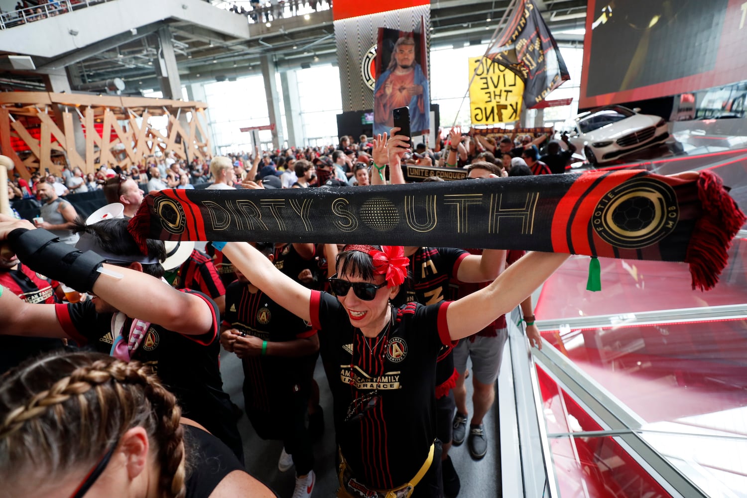 Atlanta United supporters chant as they march toward their section before the game against Orlando on Sunday at Mercedes-Benz Stadium. (Miguel Martinez /Miguel.martinezjimenez@ajc.com)