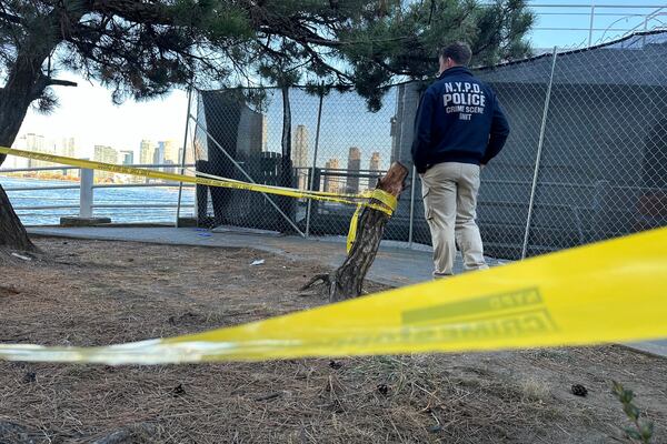 An NYPD officer works at the scene of a stabbing in New York, Monday, Nov. 18, 2024. (AP Photo/David R. Martin)