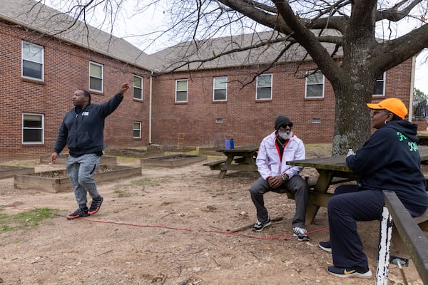 Volunteers with C.H.O.I.C.E.S mobile food pantry take a break in front of the Fulton County Oak Hill Child, Adolescent & Family Center in Atlanta on Friday, February 10, 2023. The complex will become home to a county behavioral crisis center. (Arvin Temkar / arvin.temkar@ajc.com)