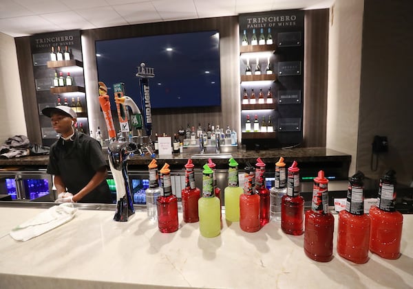 An employee prepares the stock in the bar at the Delta Sky360 Club for the Super Bowl inside Mercedes-Benz Stadium on Tuesday, Jan. 22, 2019, in Atlanta. (Curtis Compton/ccompton@ajc.com)