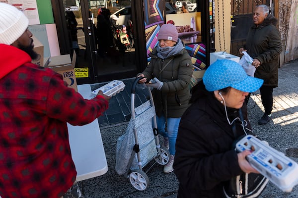 Abou Sow hands out cartons of eggs to people waiting in line to receive free eggs from FarmerJawn Agriculture, Friday, March 21, 2025, in the Harlem neighborhood of New York. (AP Photo/Julia Demaree Nikhinson)