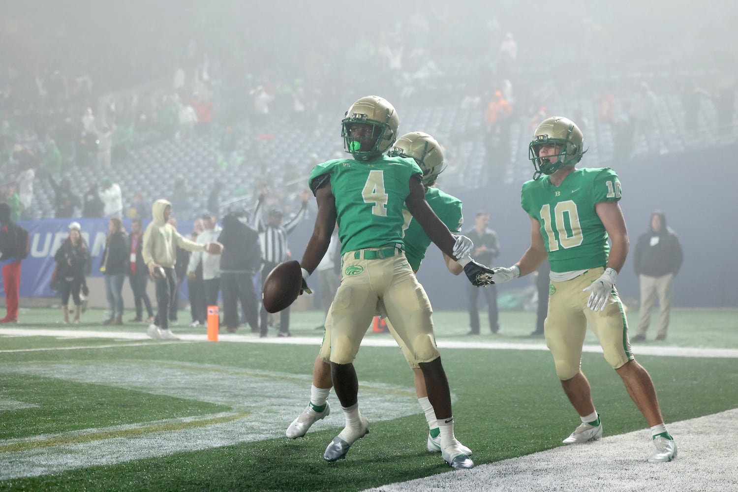 Buford wide receiver Tobi Olawole (4) celebrates with teammates after he made a go-ahead touchdown catch against Langston Hughes during the fourth quarter of the Class 6A state title football game at Georgia State Center Parc Stadium Friday, December 10, 2021, Atlanta. JASON GETZ FOR THE ATLANTA JOURNAL-CONSTITUTION