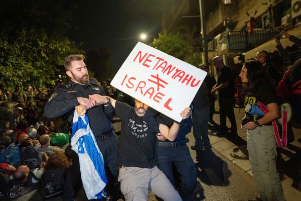 Police disperse people protesting against Prime Minister Benjamin Netanyahu's government and calling for the release of hostages held in the Gaza Strip by the Hamas militant group, near the Prime Minister's residence in Jerusalem, Monday, Oct. 28, 2024. (AP Photo/Ohad Zwigenberg)