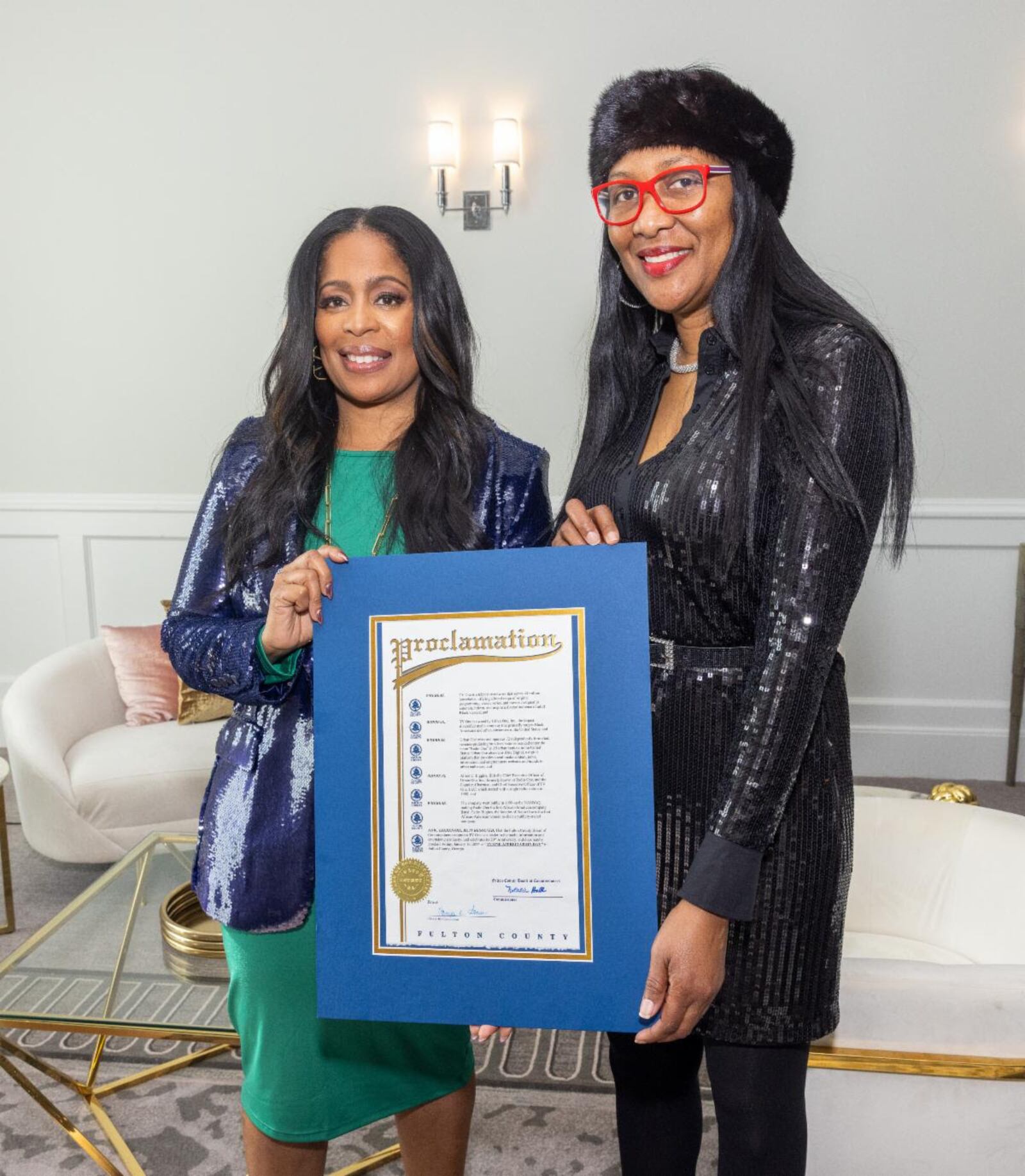 Fulton County District 4 Commissioner Natalie Hall (right) presents a Proclamation to TV One and CLEO TV president Michelle L. Rice on behalf of the Fulton County Board of Commissioners, pronouncing Jan. 19 as Urban One Day.