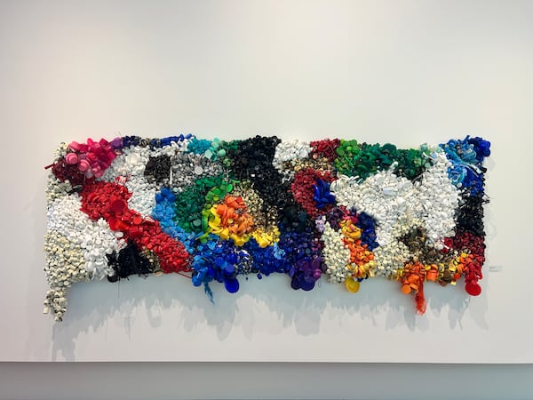 Rebecca Des Marais' 288-inch-wide “Coffin Cover,” comprised of plastic bottle caps and other discarded objects tied to plastic webbing.