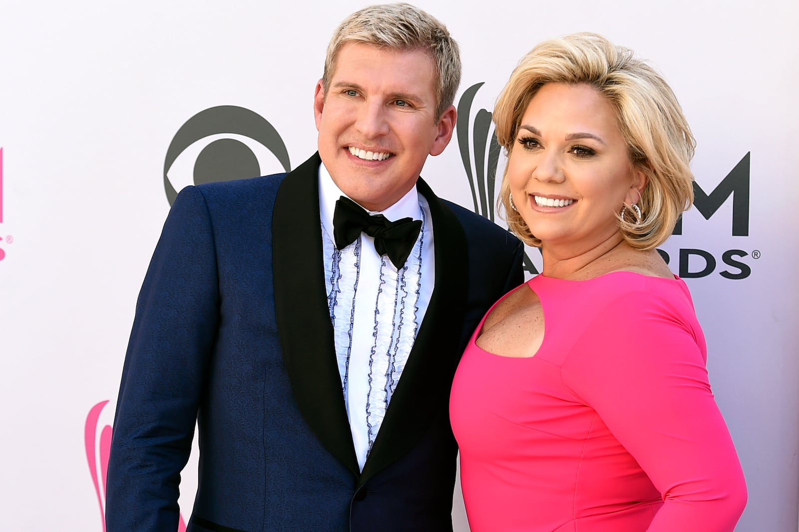 FILE - Julie Chrisley, right, and her husband Todd Chrisley pose for photos at the 52nd annual Academy of Country Music Awards on April 2, 2017, in Las Vegas. (Jordan Strauss/Invision/AP, File)