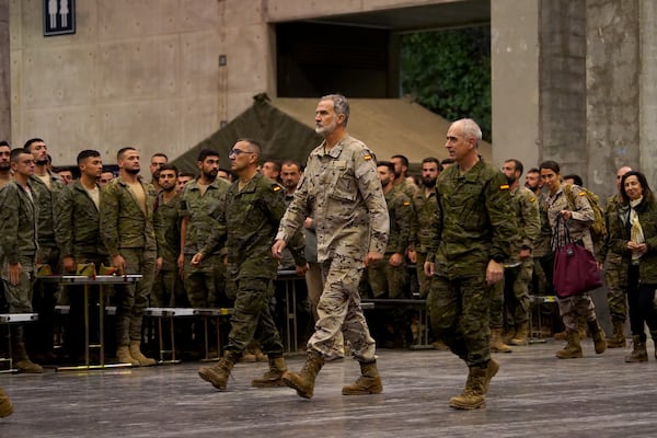 Spain's King Felipe VI, visits a military base on the outskirts of Valencia after floods left hundreds dead or missing in the Valencia region in Spain, Tuesday, Nov. 12, 2024. (AP Photo/Alberto Saiz)