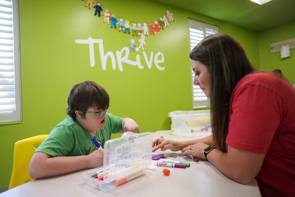 Noah Cole works with volunteer Kayla Cox, right, as they create art in the special needs ministry Thrive Special Needs Ministry at First Baptist Church Woodstock, Wednesday, March 20, 2024, in Woodstock, Ga. (Jason Getz / jason.getz@ajc.com)