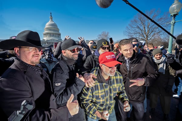 Oath Keepers founder Stewart Rhodes, from left, former Proud Boys leader Enrique Tarrio, Joseph Biggs and Zachary Rehl pose at a news conference at the U.S. Capitol in Washington, Friday, Feb. 21, 2025. (AP Photo/J. Scott Applewhite)