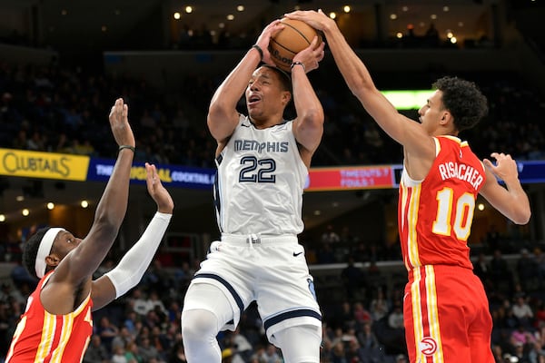 Memphis Grizzlies guard Desmond Bane (22) shoots against Atlanta Hawks forwards Zaccharie Risacher (10) and Onyeka Okongwu in the first half of an NBA basketball game, Monday, March 3, 2025, in Memphis, Tenn. (AP Photo/Brandon Dill)