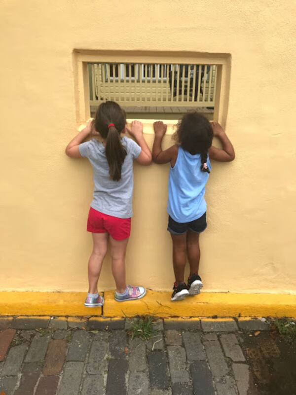 "This picture was taken in St. Augustine, Fl. These girls are cousins but more like sisters," wrote Chrissi L. Denman of Marietta. "They were both curious and tried looking through this window in downtown St. Augustine. Vivienne (my niece) is on the left and Everly (my daughter is on the right)."