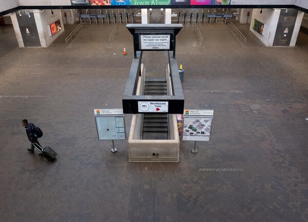 200320-Atlanta-A lone person walks across the plaza at the Five Points MARTA station during rush hour Friday morning March 20, 2020. MARTA rail ridership has dropped off dramatically with the coronavirus pandemic. (Ben Gray for The Atlanta Journal-Constitution)