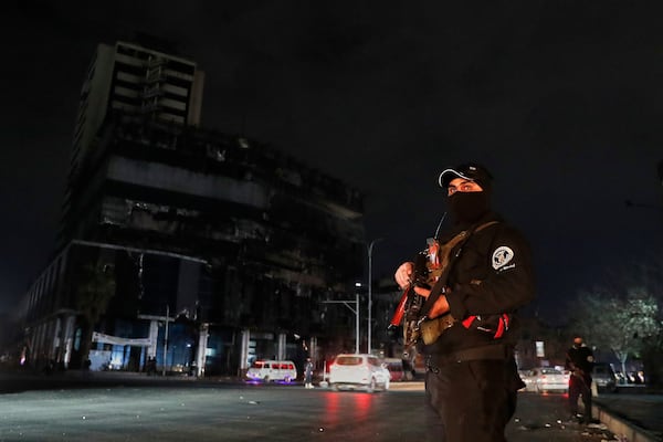 A member of the Syrian government security forces stands guard at a street in Damascus, Syria, Thursday, March 6, 2025. (AP Photo/Omar Sanadiki)