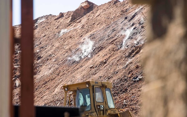 Smoke can be seen rising from an unlicensed landfill, located at 7635 Bishop Road, in South Fulton, Wednesday, Feb. 13, 2019. (ALYSSA POINTER/ALYSSA.POINTER@AJC.COM)