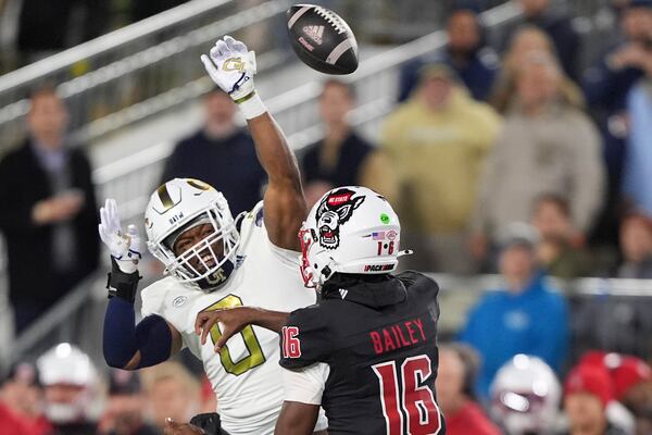 Georgia Tech linebacker Trenilyas Tatum (0) blocks a pass thrown by North Carolina State quarterback CJ Bailey (16) during the first half of an NCAA college football game, Thursday, Nov. 21, 2024, in Atlanta. (AP Photo/Brynn Anderson)