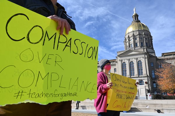 December 15, 2020 Atlanta -  Participants hold signs during a protest to urge a stop of standardized testing during the COVID-19 pandemic, at Liberty Plaza in Atlanta on Tuesday, December 15, 2020. (Hyosub Shin / Hyosub.Shin@ajc.com)