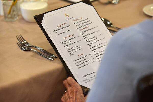 When Lenbrook opened in 1983, it had just one dining room where residents filled out an order ticket with their dinner choices. Now residents choose their meals from menus and place their orders with members of the wait staff. HYOSUB SHIN / HSHIN@AJC.COM