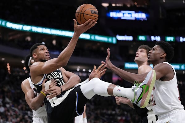 Cleveland Cavaliers' Jarrett Allen fouls Milwaukee Bucks' Giannis Antetokounmpo during the first half of an NBA basketball game Sunday, Mar. 9, 2025, in Milwaukee. (AP Photo/Morry Gash)