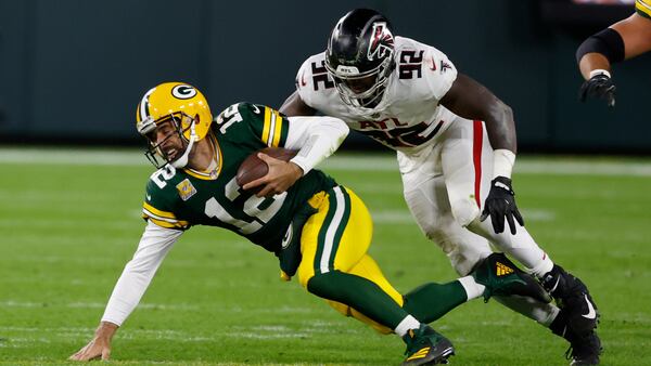 Packers QB Aaron Rodgers is sacked by Charles Harris of the Falcons during the second half.