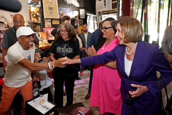 Musician Chicago Mike of Kool and the Gang greets U.S. House Speaker Nancy Pelosi during a visit Thursday to the Madame C.J. Walker Museum in Sweet Auburn. (Jason Getz / Jason.Getz@ajc.com)