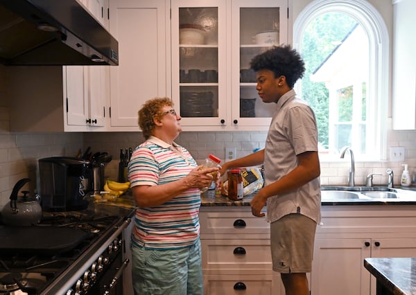 Judy Veschi talks with one of her adopted children, Aaron, 14, at their home in Alpharetta on Wednesday, September 9, 2020. (Hyosub Shin / Hyosub.Shin@ajc.com)