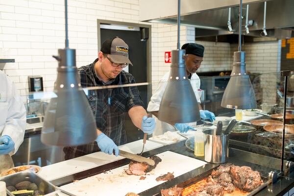  South Region prepared foods coordinator for Whole Foods, Quentin Arndt, working the line at The Roast./ Photo credit- Mia Yakel.