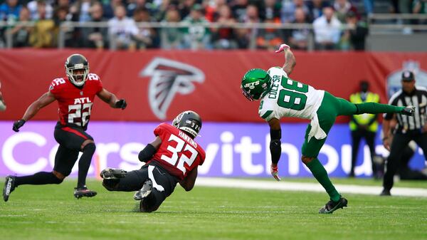 Falcons safety Jaylinn Hawkins (32) makes an interception during the first half against the New York Jets Sunday, Oct. 10, 2021, at Tottenham Hotspur stadium in London, England. (Ian Walton/AP)