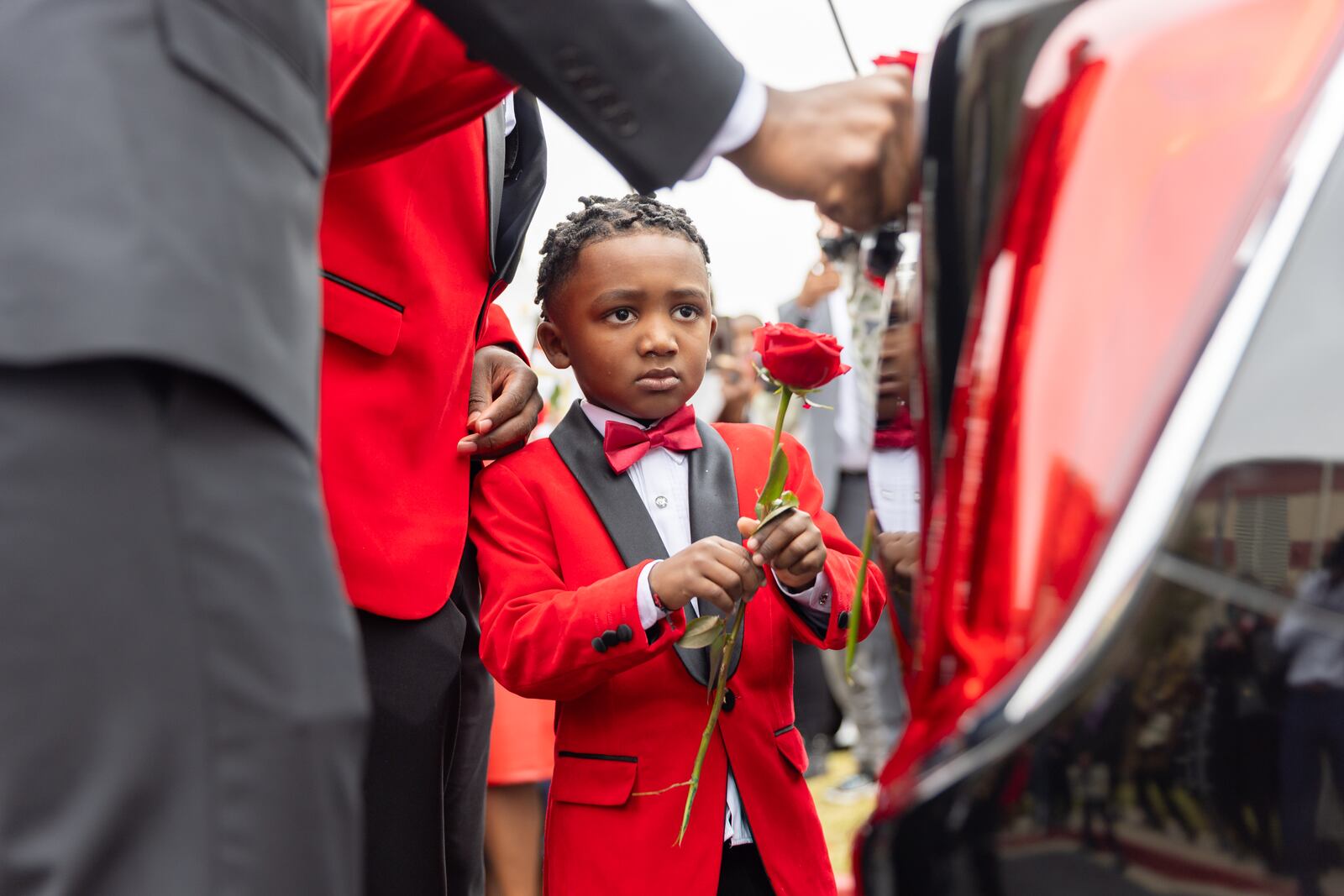 Tristan Kearney, 5, places a rose on his grandmother Wanda Smith’s hearse outside Word of Faith Cathedral in Austell.