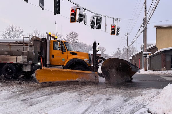 Snow is cleared from the streets in Lowville, N.Y., on Saturday, Nov. 30, 2024. (AP Photo/Cara Anna)