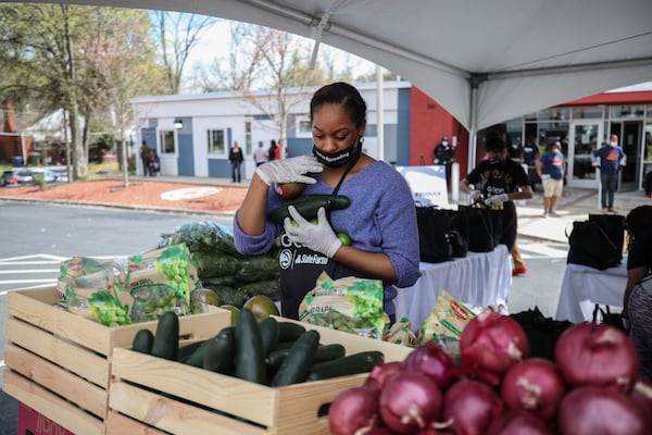 A woman grabs fresh produce.  BRANDEN CAMP/SPECIAL