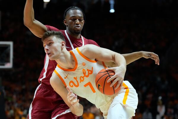 Tennessee forward Igor Milicic Jr. (7) drives against Alabama forward Mouhamed Dioubate, top, in the first half of an NCAA college basketball game Saturday, March 1, 2025, in Knoxville, Tenn. (AP Photo/Mark Humphrey)