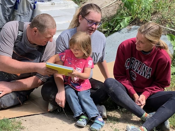 For a group of Americans visiting Poland as part of a Habitat for Humanity trip, breaks provided the perfect opportunity to connect with members of the Kawka family. Here, Jan Wegierski (left), a contractor with Habitat for Humanity Poland, is joined by volunteers Irene Devine (center) and Natalie Smith (right) with the Kawkas’ 3-year-old daughter, Amelka. It was one of several touching moments that unfolded during the trip. MARK A. WALIGORE / MARK.WALIGORE@AJC.COM