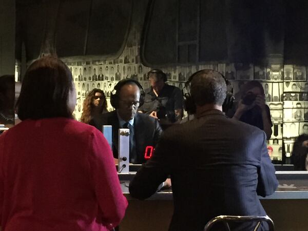 Lester Holt trying out a simulated segregated lunch counter sit in, which features the sound and feel of being bullied. CREDIT: Rodney Ho/rho@ajc.com