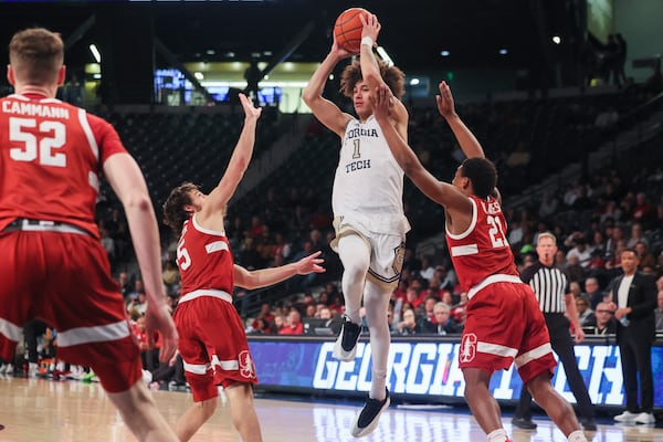 Georgia Tech guard Naithan George (1) passes against Stanford guard Benny Gealer (5) and Stanford guard Jaylen Blakes (21) during the second half against Stanford at McCamish Pavilion, Wednesday, February, 12, 2024, in Atlanta. Georgia Tech won 60-52. (Jason Getz / AJC)