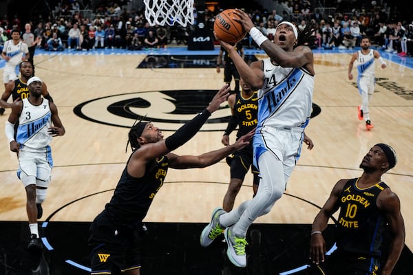 Atlanta Hawks guard Garrison Mathews (24) shoots against the Golden State Warriors during the first half of an NBA basketball game, Saturday, March 22, 2025, in Atlanta. (AP Photo/Mike Stewart)