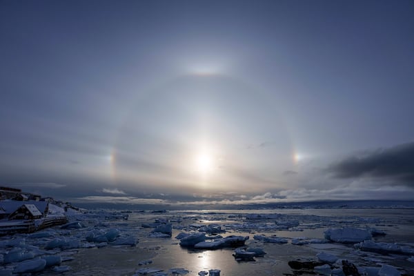 FILE - A halo is seen during a sunset on the coast of sea inlet of Nuuk, Greenland, Friday, March 7, 2025. (AP Photo/Evgeniy Maloletka, File)