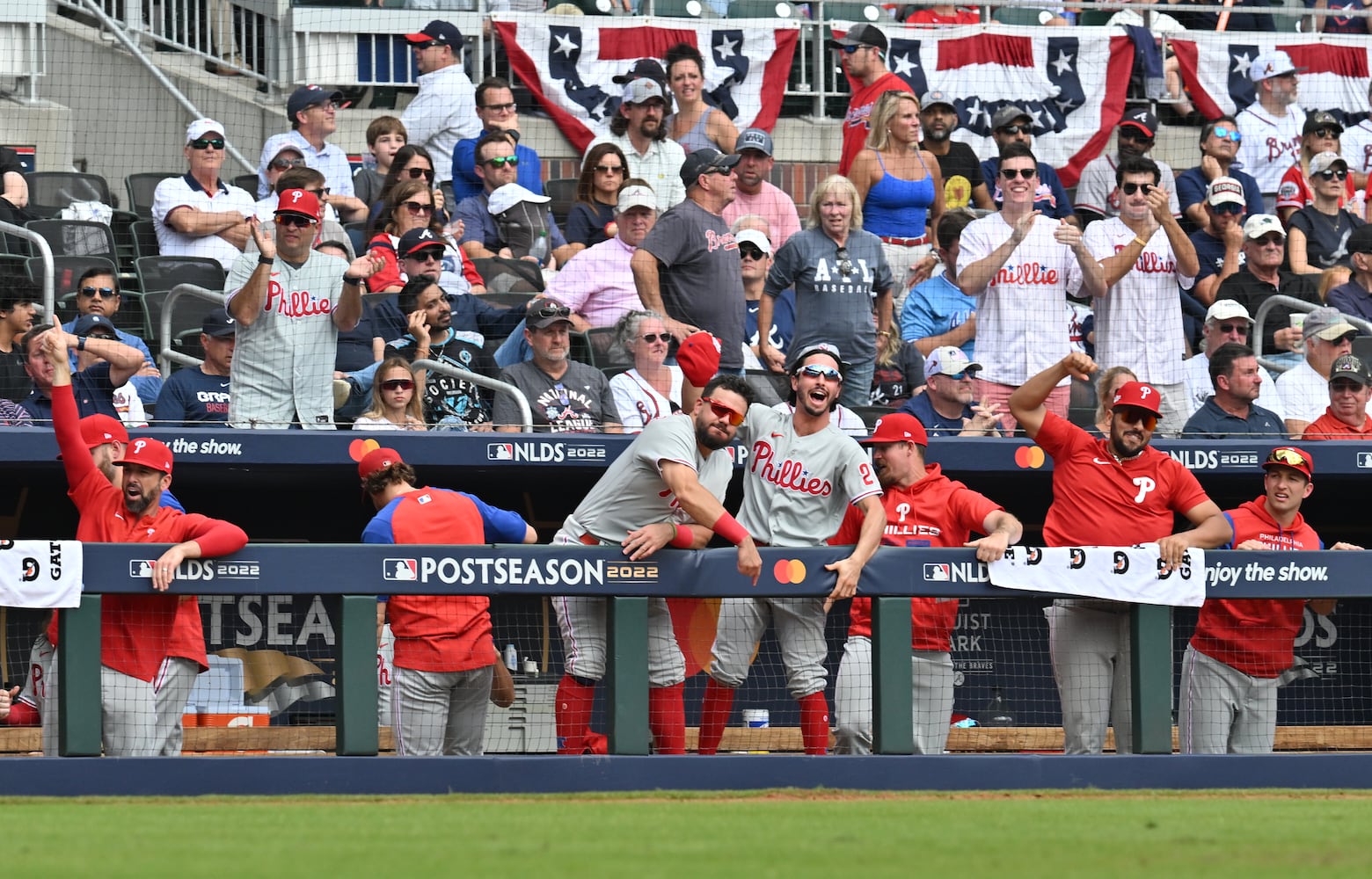 Philadelphia Phillies celebrate after Edmundo Sosa (33) scores on an RBI single by Nick Castellanos during the fourth inning of game one of the baseball playoff series between the Braves and the Phillies at Truist Park in Atlanta on Tuesday, October 11, 2022. (Hyosub Shin / Hyosub.Shin@ajc.com)