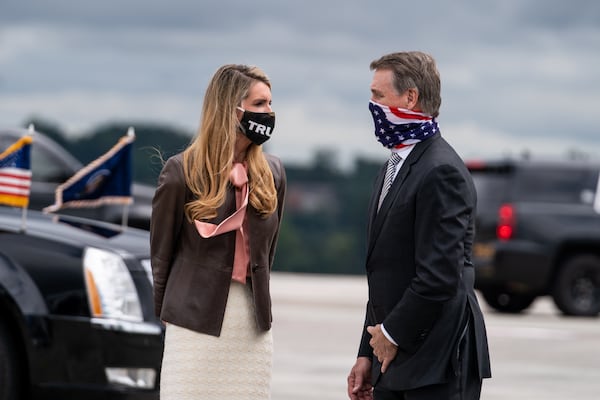 Sens. Kelly Loeffler, R-Ga., and David Perdue,R-Ga., wait to greet President Donald Trump as he exits Air Force One in Atlanta, Sept. 25, 2020. (Anna Moneymaker/The New York Times)