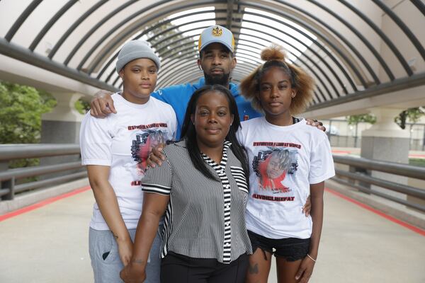 Ashley Heard (center) the mother of 15-year-old Charles Brown poses for a photo with her daughter-in-law Nicole Gantt( left), her husband Franklin Gillis (back), and daughter Takayla Blake (right) on Friday, June 16, 2023. Brown was fatally shot two weeks ago in Cobb County. (Natrice Miller/ natrice.miller@ajc.com)