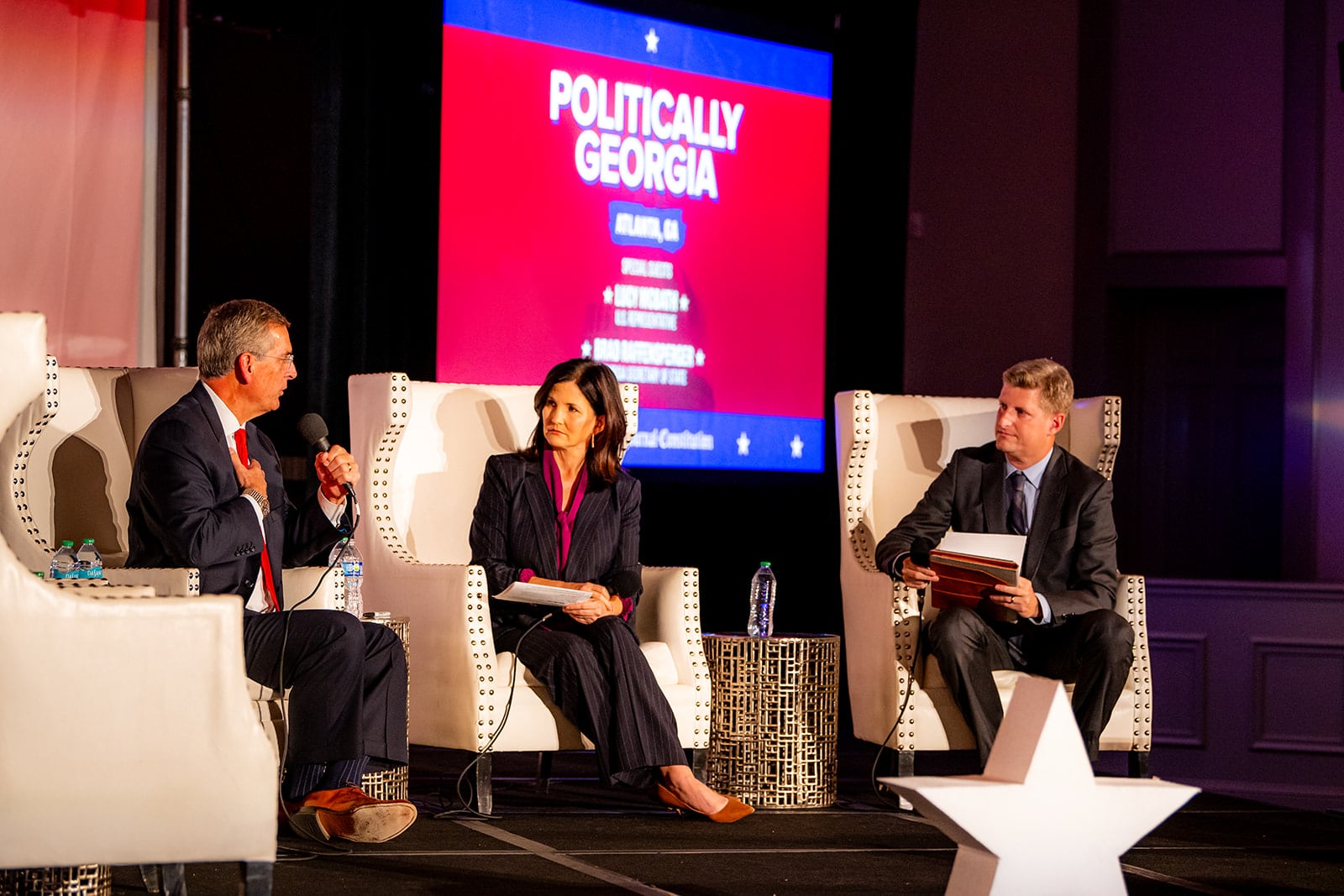 Georgia Secretary of State Brad Raffensperger answers a question as AJC journalists Patricia Murphy and Greg Bluestein listen at a Politically Georgia event in Buckhead on Tuesday.