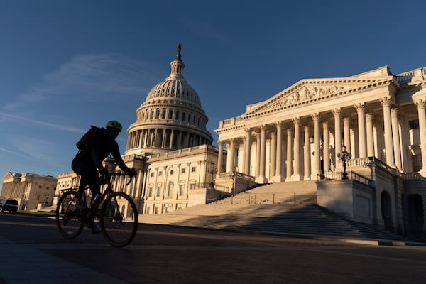 A cyclist rides by the U.S. Capitol  in Washington.