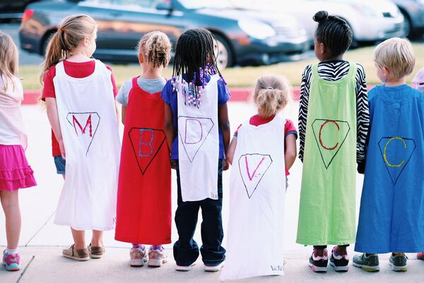 Photo taken last year at Alpharetta Elementary on Cape Day where six-year-old Hudson Lillystone is a student. Hudson has battled against acute lymphoblastic leukemia (ALL) at the Aflac Cancer and Blood Disorders Center at Children’s. Photographer Aaron Coury.