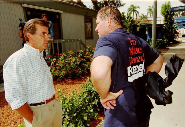 Braves General Manager John Schuerholz L chats with team manager Bobby Cox at the Braves spring training stadium after players and management put aside their differences for the time being as the major leaguers begin to report to training camp.