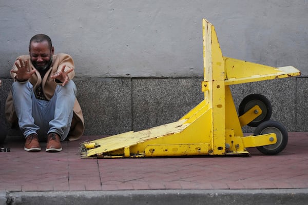 A person reacts near a temporary barriers set up in the French Quarter, Thursday, Jan. 2, 2025, in New Orleans. (AP Photo/George Walker IV)